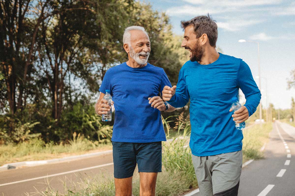 Two men exercising and running on a road in Naples, Florida | Men's Medical Weight Loss Center Specialists in Weight Loss for Men Naples, Florida